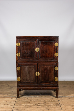 A Chinese four-door wooden brass mounted cabinet, 20th C.