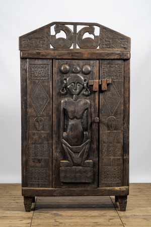 A decorative wooden African-inspired single-door cupboard, 20th C.
