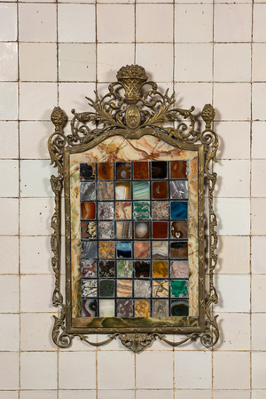 A pietra dura plaque mounted in a brass frame, 20th C.