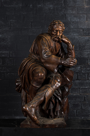 A large walnut sculpture of a resting man, 18/19th C.
