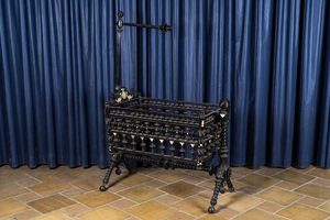 An attractive ebony-inlaid ebonised wooden cradle, 19th C.