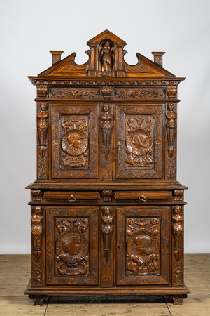 A richly carved baroque-style oak and walnut four-door cabinet, 19th C.