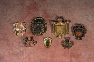 Seven partly gilt polychrome wood carvings of coats of arms, 17th C. and later