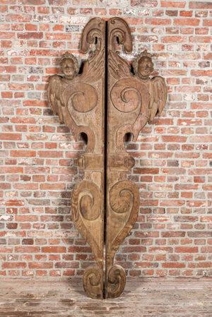 A pair of large carved oak reliefs with winged cherub heads, 18th C.