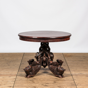 An Anglo-Indian colonial table on a well-carved stand with lions and peacocks, 19th C.