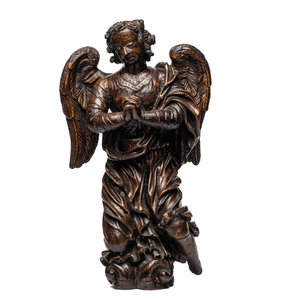 A carved oak figure of a kneeling and praying angel with traces of polychromy, 17th C.