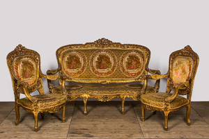 A Louis XV-style gilt wooden salon set comprising a three-seater sofa and two armchairs, 20th C.