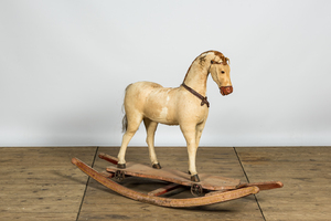 A wooden rocking horse covered with natural fur, early 20th C.