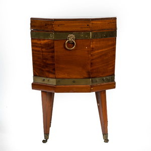 An octagonal mahogany box on four mobile feet, 19th C.