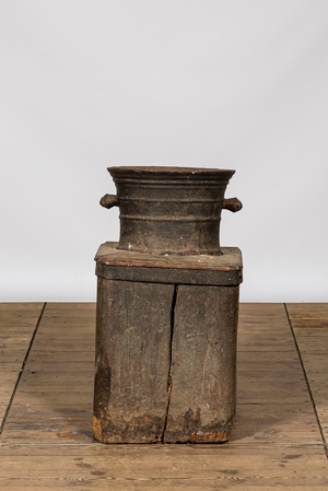 A large iron mortar on wooden stand, 17th C.