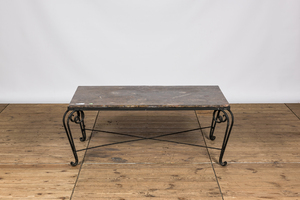 A wrought iron coffee table with marble top, 20th C.