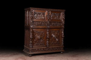 A Flemish richly carved oak 'beeldenkast' or cupboard, 17th C.