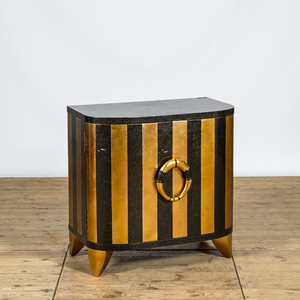A curved black and gilt lacquered wooden two-door cabinet, 20th C.