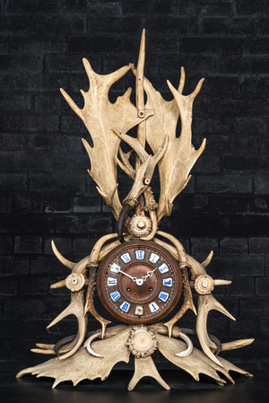 A Black Forest 'wild boar teeth and antlers' mantle clock, 19th C.