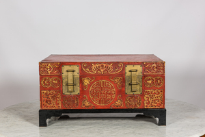 A Chinese red lacquered bronze-mounted travel trunk on foot, 20th C