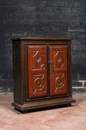 A polychromed walnut and pine wood two-door cupboard, probably Germany, 19th C.