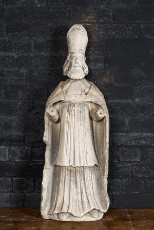A large limestone sculpture of a standing bishop, 18th C.