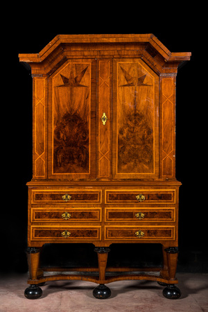 A German baroque mahogany- and root wood veneer star-cabinet on ebonised feet, 18th C.