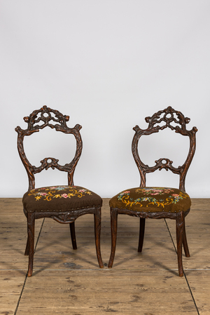 A pair of 'Black Forest' wooden chairs with embroidered upholstery, ca. 1900