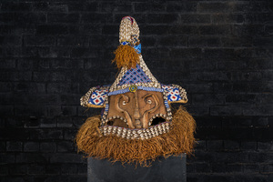 A Kuba helmet mask (mukenga) with cowrie shells, Congo, 20th C.