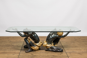 A coffee table with a glass top resting on two polyester Moorish figures, Italy, 2nd half 20th C.