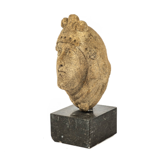 A granite head of a lady wearing a flowery crown, 17th C.