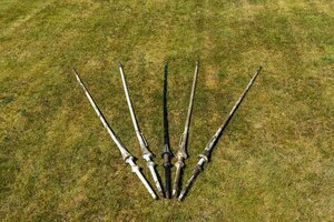 Five patinated wooden lances, 19/20th C.