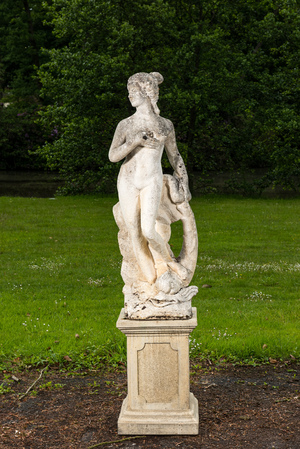 A white painted concrete garden sculpture of a sea nimph with a dolphin, Italy, 20th C.