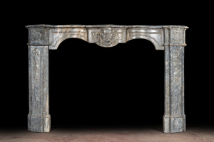 A French Louis XV-style gray marble fireplace with mascaron, 19th C.