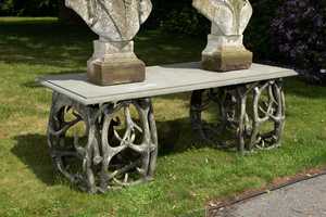 An impressive exterior table with bluestone top on entwined polyester antlers, 20th C.