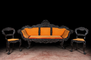 An Anglo-Indian colonial carved wooden sofa with two matching chairs, late 19th C.