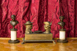 A pair of patinated bronze busts on a pedestal and a bronze ink set with playful heads, 19th C.