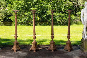 Four large cast iron church candlesticks, 20th C.