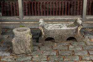 A carved stone double arch-shaped garden ornament and a bird bath, 19th and 20th C.