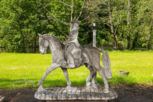 A large concrete garden statue with lighting in the shape of a galant rider on horse, 20th C.