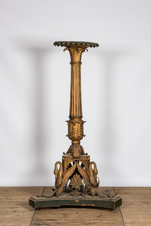 An imposing polychrome and gilt metal candlestick on a wooden base, 20th C.