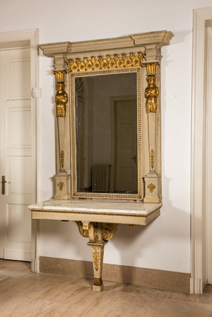 An impressive French Empire-style gray-patinated and gilt wooden mirror console with marble top, 19th C