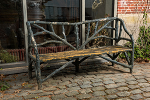 A garden bench in a patinated faux bois structure, 20th C.