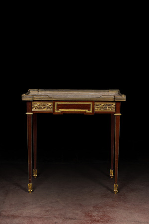 A French Louis XVI-style bronze and brass mounted mahogany side table with marble top, 19/20th C.