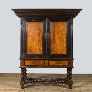 A mahogany and partly ebonised wooden two-door cupboard on foot, 19th C.