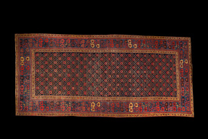 An Oriental rug with geometric motifs and floral design, wool on cotton, 20th C.