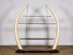 A large étagère with glass shelves set in faux ivory tusks, 20th C.