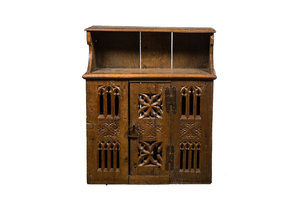 An English Gothic carved oak hanging cupboard composed of old elements, 17th C. and later